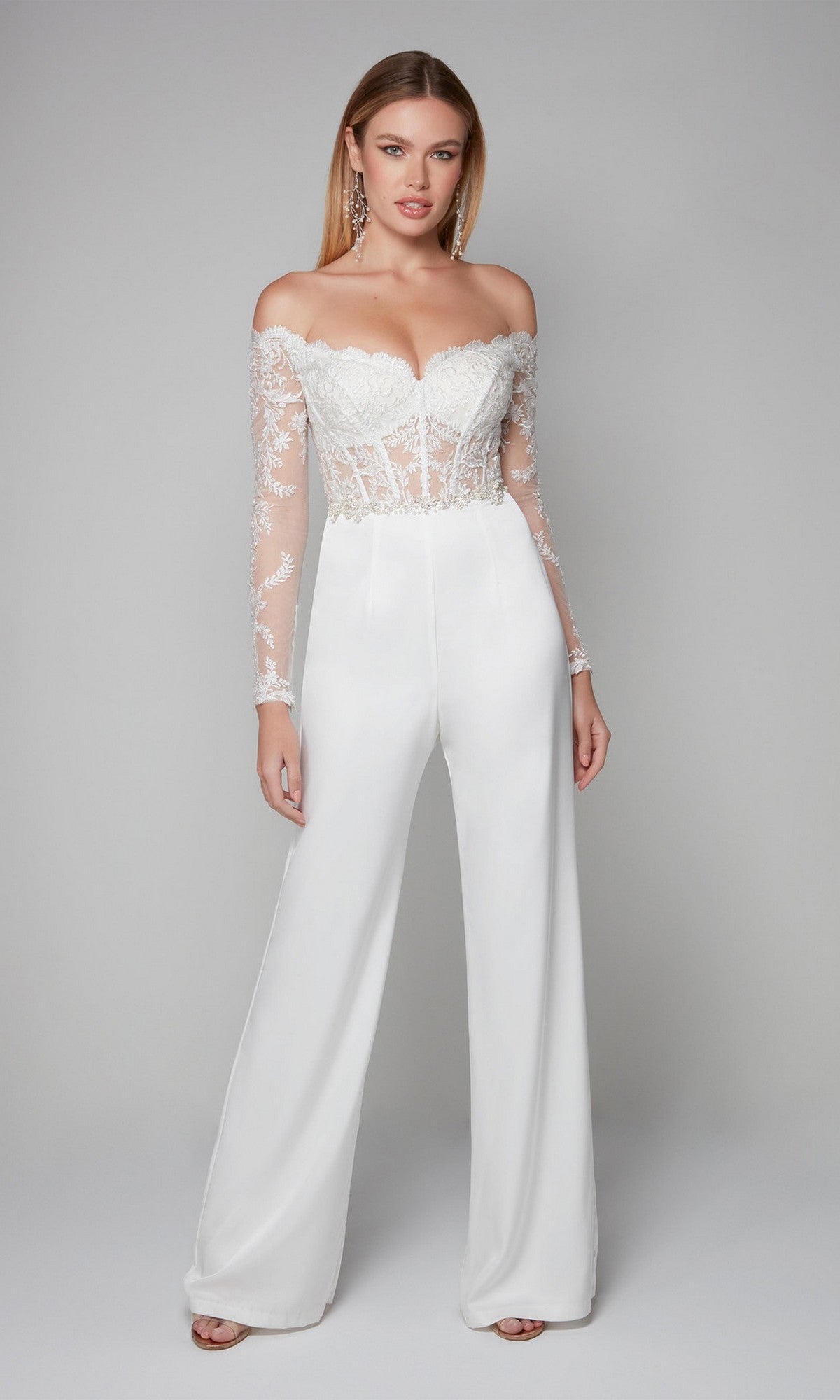 Model wearing the Alyce 70018 Long Formal Jumpsuit, a white off-the-shoulder design with lace embroidery, long sleeves, and wide-leg pants, posed against a plain light gray background.